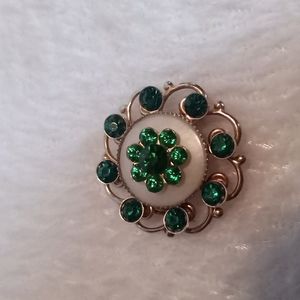 Vintage brooch. Gold toned with green rhinestones